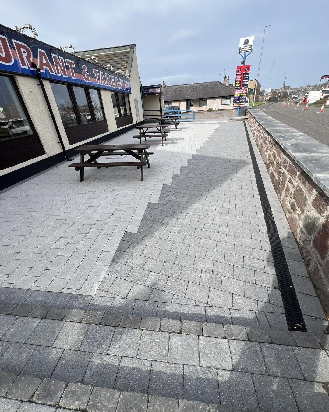 Large commercial paved area outside a local restaurant