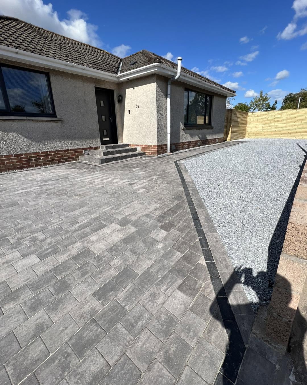 Grey block-paved driveway with chip border to a bungalow